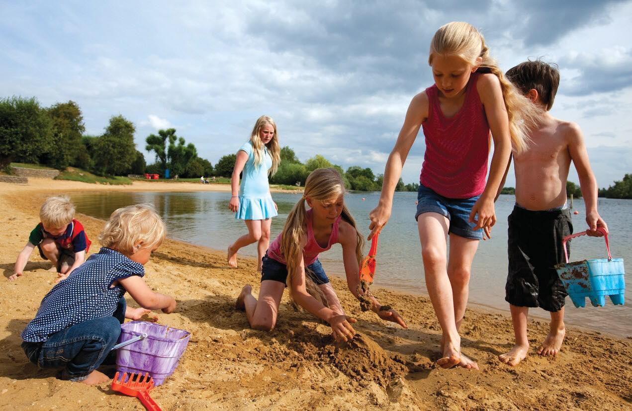 people playing on the beach, representing beaches near cotswolds
